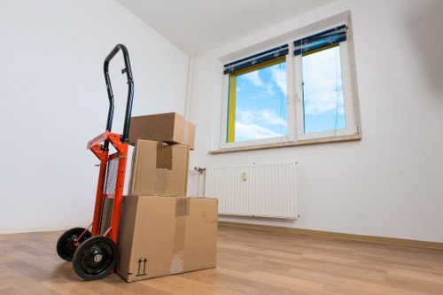 Removal team carrying household items through a Kingston flat entrance